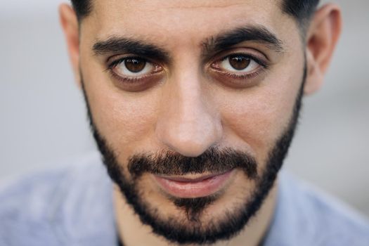 Face of bearded caucasian armenian young man looking at camera. Attractive guy stand on street city lifestyle. People. Beauty. Stand outdoors.