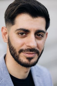 Close-up portrait of nice-looking caucasian multi-race beautiful businessperson elegant young man looking into camera. Career people. Fashion, beauty. Male portraits