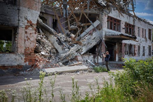 War correspondent photographs destroyed buildings after the bombing of the Chernihiv city in Ukraine. War in Ukraine.