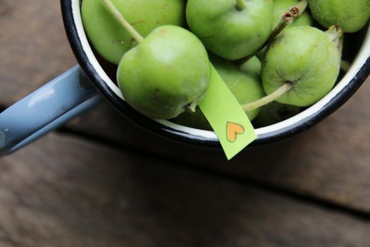 Natural food idea. Green apples and a tag with a heart. High quality photo