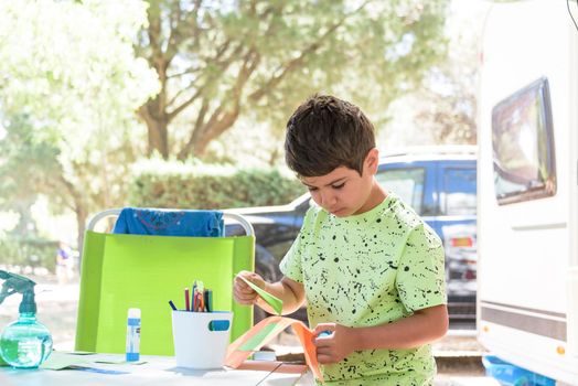 Primary school boy doing manual work while on vacation and preparing to go back to school