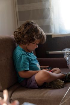 Happy little Boy Playing Video Games. Child using video game Controller. Kid with Joystick playing Computer Game