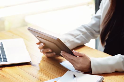 business woman using a tablet computer for data analysis, marketing, accounting.