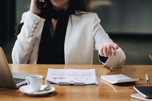 financial, Planning, Marketing and Accounting, Asian woman Economist using calculator to calculate investment documents.