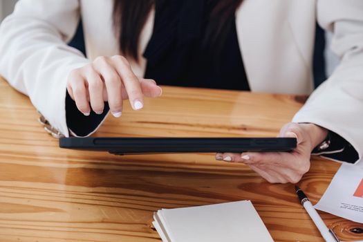 business woman using a tablet computer for data analysis, marketing, accounting.