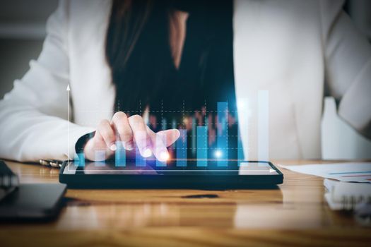 business woman using a tablet computer for data analysis, marketing, accounting.