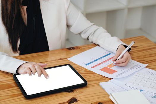 business woman using a tablet computer for data analysis, marketing, accounting.