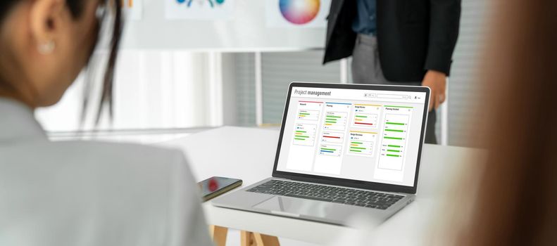 Project planning software for modish business project management on the computer screen showing timeline chart of the team project