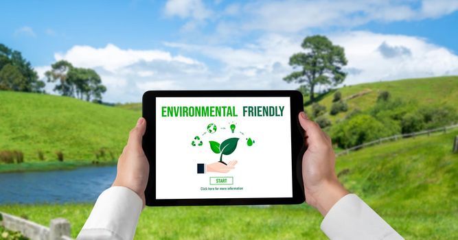 Green business transformation for environment saving and ESG business concept. Businessman using tablet to set corporate goal toward environmental friendly management and alternative clean energy use.