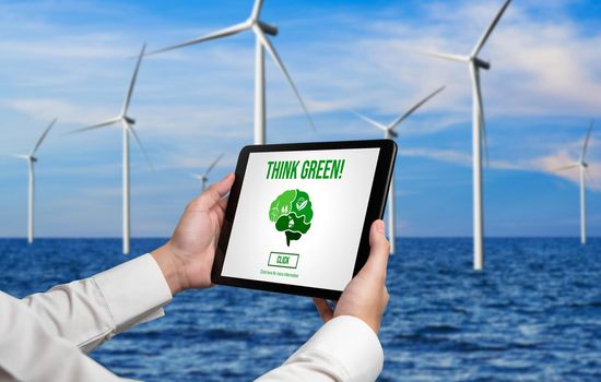 Green business transformation for environment saving and ESG business concept. Businessman using tablet to set corporate goal toward environmental friendly management and alternative clean energy use.