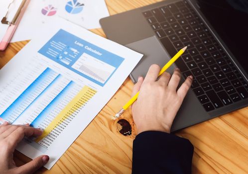 A woman using a computer to calculate the loan interest rate