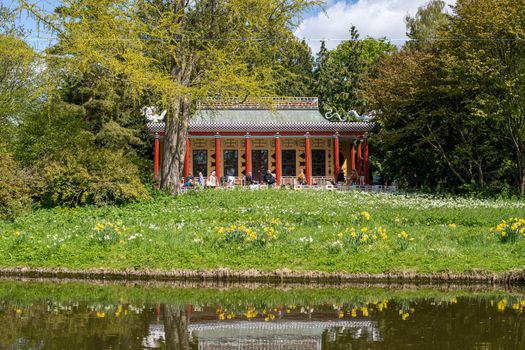 Copenhagen, Denmark - May 07, 2022: People at the historic Chinese Pavilion in Frederiksberg Gardens