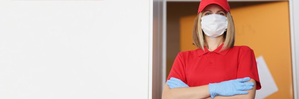 Portrait of woman in red uniform wear protective face mask and gloves, importance of wearing protection in virus times. Prevention of covid spread concept