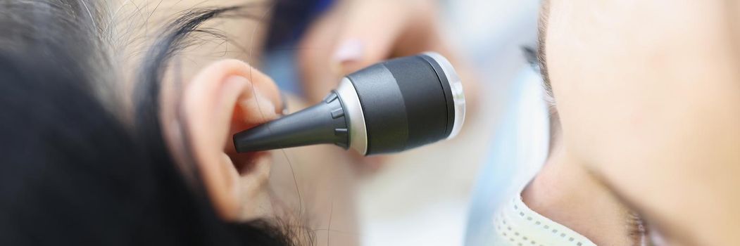 Close-up of doctor check patient on medical examination with special ear equipment. Appointment in hospital at otolaryngologist specialist. Health concept