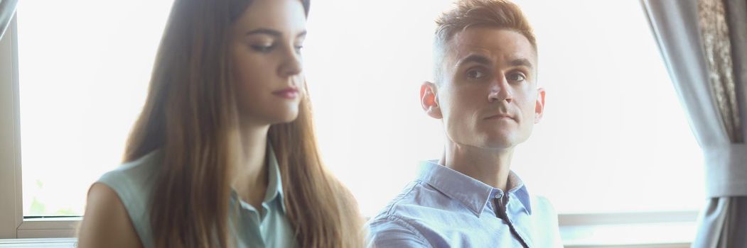 Portrait of female and male sitting in cafe on business meeting, business partners or colleagues. Ready to discuss all working moments. Business concept