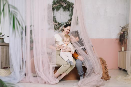 happy mother with her children in the bedroom at home