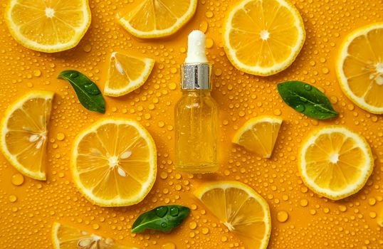 Bottle of cosmetics and drops of liquid, moisturizing lemon. Hyaluronic acid. Selective focus. Spa.