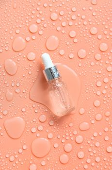 Bottle of cosmetics and drops of liquid, moisturizing. Hyaluronic acid. Selective focus. Spa.