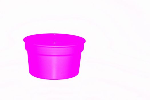 a wide mouthed cylindrical container made of glass or pottery and typically having a lid, used especially for storing product. Delicate pink purple plastic jar capacity of isolated on white