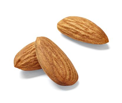 Close up of almonds on white background