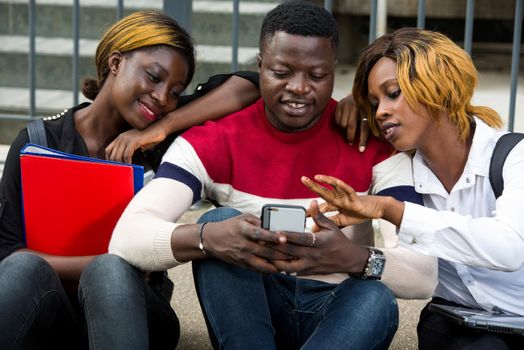 College students together study smiling with tablet, and cellphone at university campus