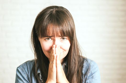 upset emotional woman on a light background. High quality photo