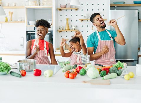 Family preparing meal and having fun in the kitchen at home