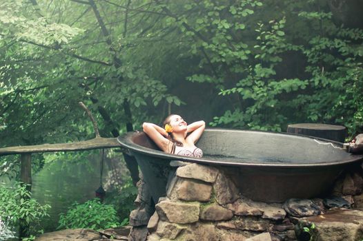 woman enjoying spa in hot tubs outdoors. High quality photo