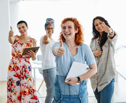 Happy young woman girls friends with thunmbs up in the office