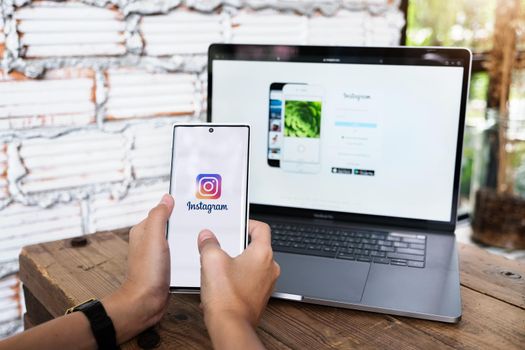 CHIANGMAI, THAILAND - June 06, 2021: A woman holding smartphone with Instagram application on the screen. Instagram is a photo sharing app for smartphones.