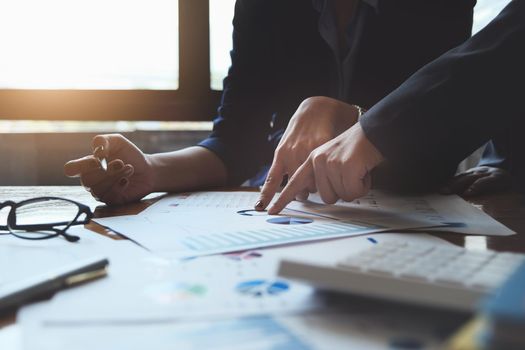 An auditor pointing to documents to examine budgets and financial fraud