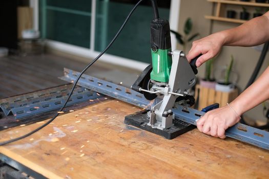 Craftsmen use iron cutters to assemble DIY projects during the holidays.