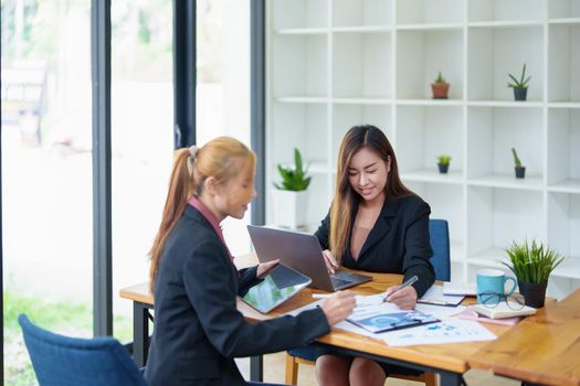 Portrait of a young Asian businesswoman consulting, planning marketing to improve product quality for customers.