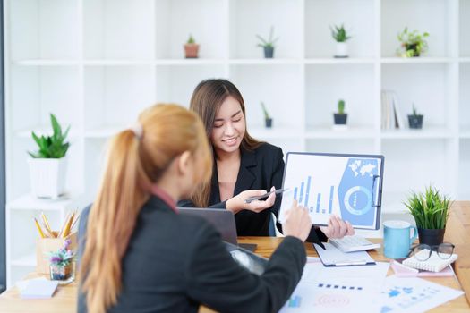 Portrait of a young Asian businesswoman consulting, planning marketing to improve product quality for customers.