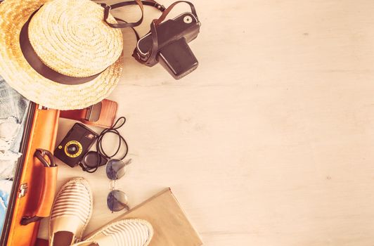 retro bag for summer vocation with photo camera, book and wicker hat. High quality photo