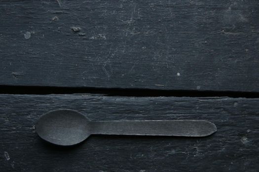 A spoon on a vintage table. Food or menu background.