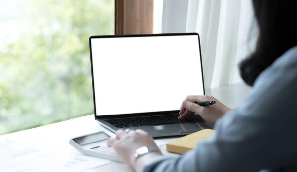 Girl at home uses laptop mockup. Modern technology in everyday life. Blank white screen place for text or template..