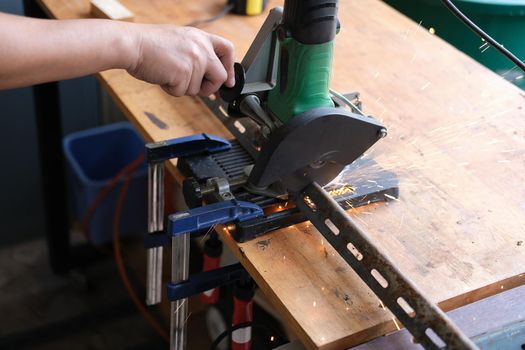 Craftsmen use iron cutters to assemble DIY projects during the holidays.