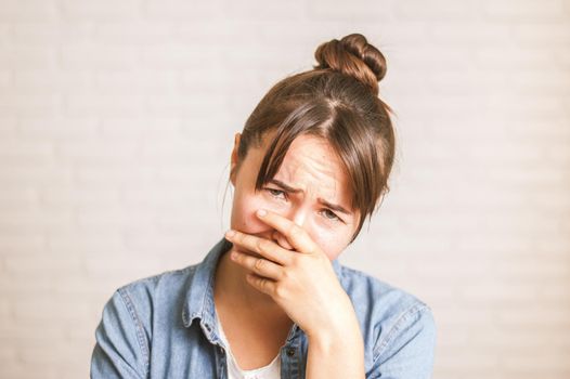 upset emotional woman on a light background. High quality photo
