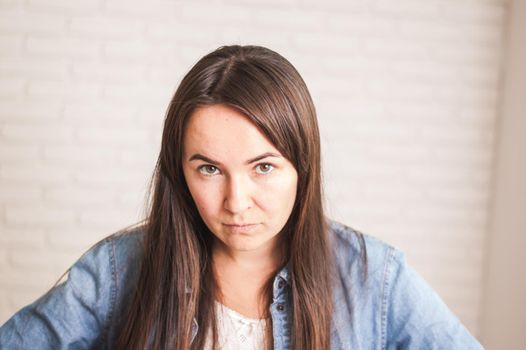 upset emotional woman on a light background. High quality photo