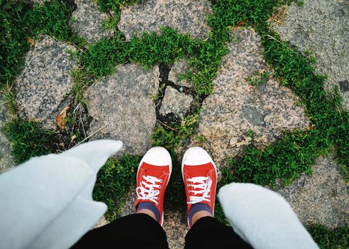 Summer walk on stones in sneakers