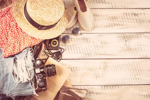 retro bag for summer vocation with photo camera, book and wicker hat. High quality photo