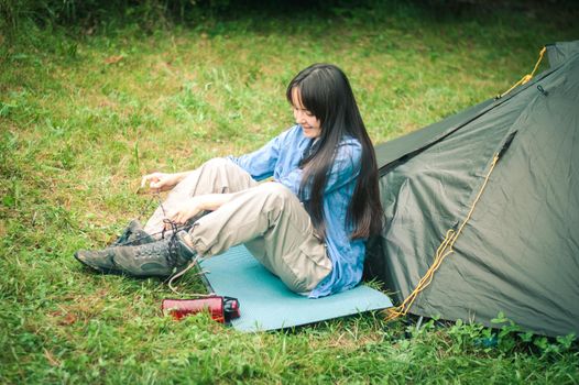 woman among the mountains near the tent enjoys nature. High quality photo