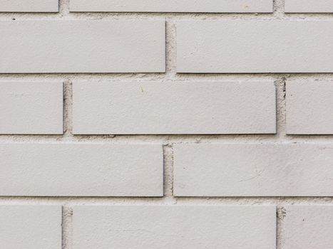 Abstract background of a gray brick wall close-up.