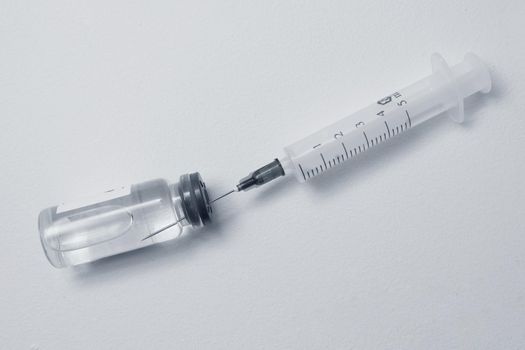 Filling syringe with medication, closeup. Vaccination and immunization. medical concept,