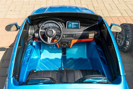 the cabin and cockpit of a children's electric car in an amusement park. The concept of a happy childhood