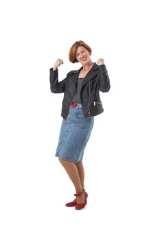 Woman in black leather jacket and skirt shows biceps demonstrates power and muscles on isolated background success strength concept
