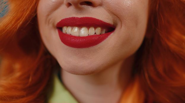 Portrait close-up of young happy redhead woman smile mouth, charming lovely ginger girl with perfect white great healthy teeth close up. Red lipstick. Female skincare model smiles wide for camera
