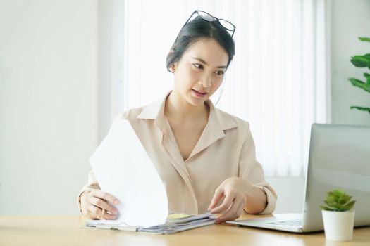 new normal, a businesswoman using computer to work for a company Via the internet on your desk at home.