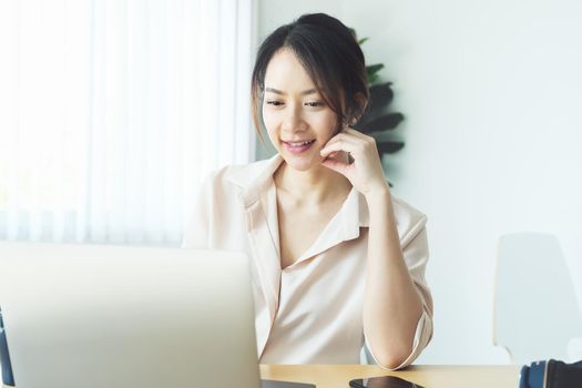 new normal, a businesswoman using computer to work for a company Via the internet on your desk at home